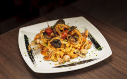 Seafood tagliatelle (squid, mussels, clams and razor clams) with tomato, chilli, garlic and parsley.
